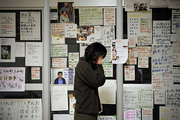 Japan survivors: Tsunami survivor stands in front of messages displayed on the wall
