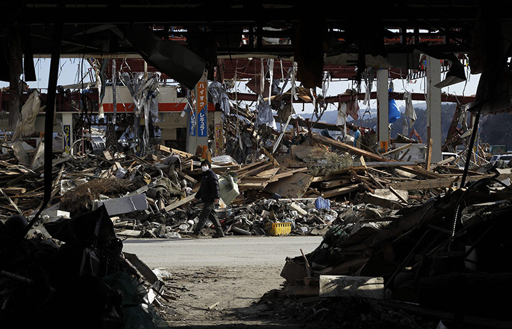 Japan aftermath: A resident is  walks through the rubble in Manami Sanriku