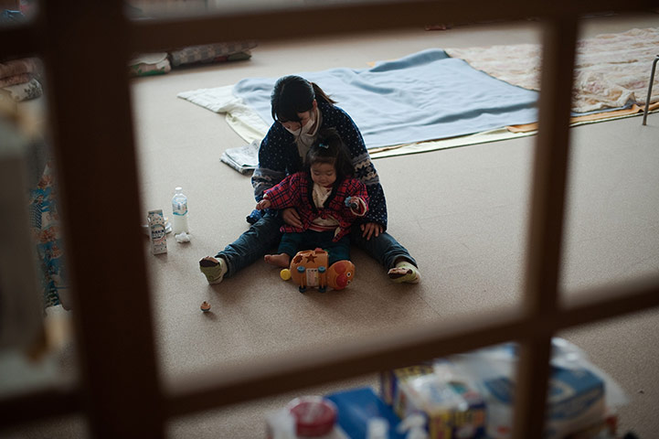 Japan aftermath: A woman plays with her daughter