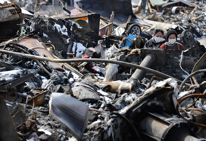Japan aftermath: People walk amid debris in Otsuchi, Iwate Prefecture 