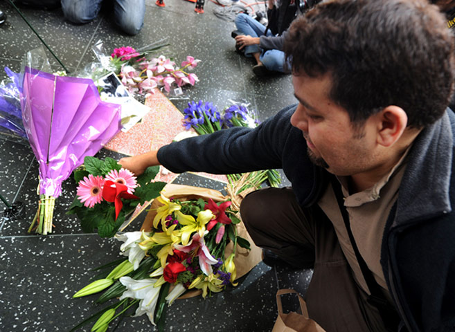 Elizabeth Taylor tribute: A fan places flowers on Elizabeth Taylor