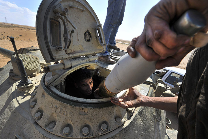 24 hours: Ajdabiya, Libya: A Libyan rebel unloads a government tank 