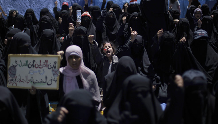 Yemen protests: a Yemeni girl shouts slogans along with female anti-government protesters