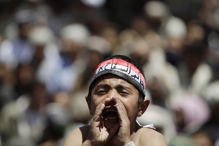 Yemen protests: a young anti-government protester shouts slogans during a rally