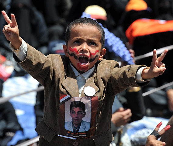 Yemen protests: a Yemeni child flashes the victory sign during a demonstration
