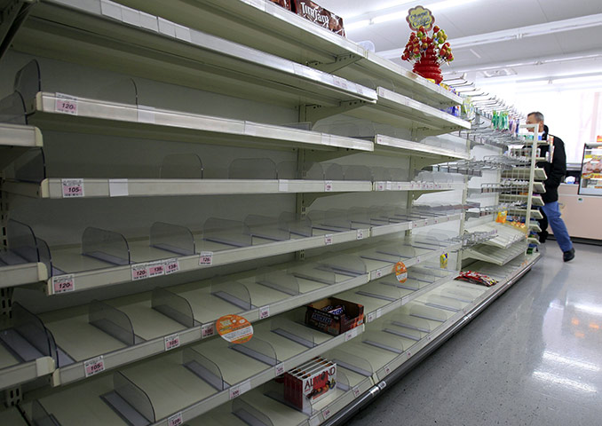 Japan : A shopper in an empty convenience store in Tokyo