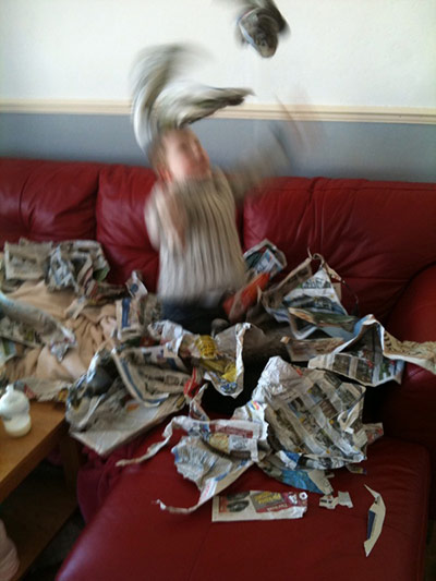 mess: three year old with newspaper