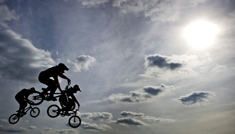 24 Hours: BMX riders jump through the air during the opening of the Olympic BMX track