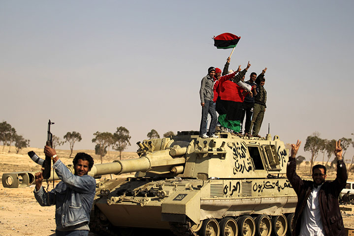 24 Hours in Pictures: Libyan rebels celebrate on a destroyed tank in Ajdabiya