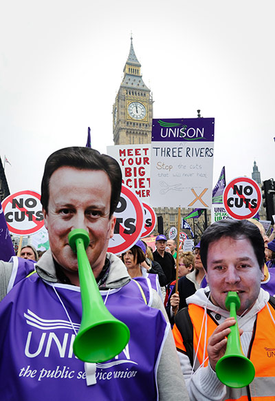 Protest against cuts: Two protestors wear David Cameron and Nick Clegg masks make 