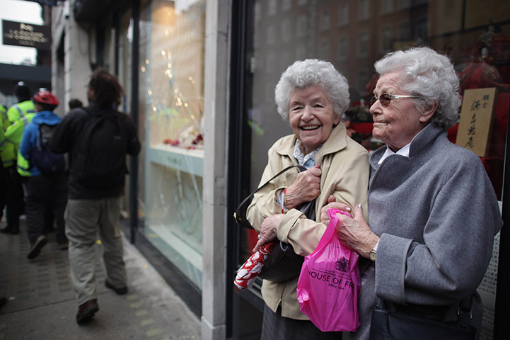London Protest: Two elderly ladies stand by as a group of protesters vandalise properties