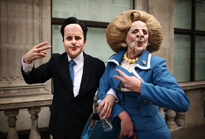 24 hours in pictures: Protestor dressed as David Cameron and Magaret Thatcher, London