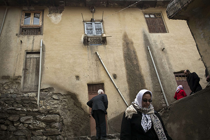 24 hours in pictures: Iranian tourists climb the stairs to visit the historic village of Masouleh
