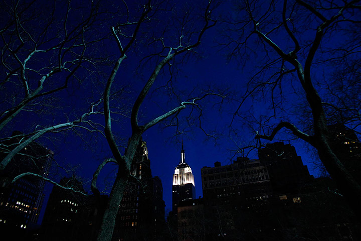 24 hours in pictures: The Empire State Building is seen lit up before Earth Hour in New York