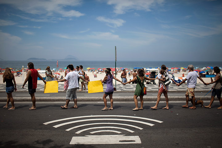 people holding hands in a line. Rio de Janeiro, Brazil: People