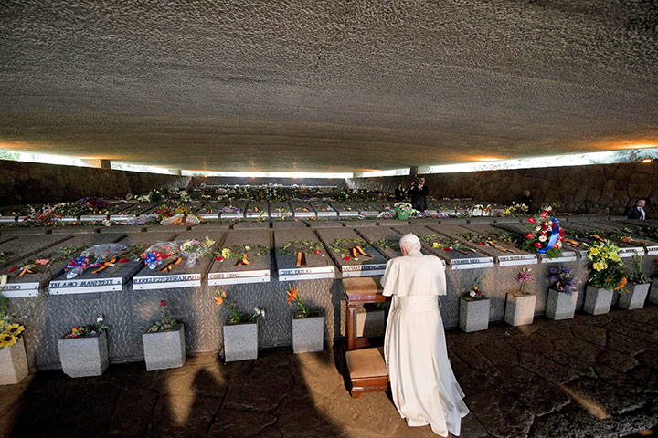 24 hours in pictures: Pope Benedict XVI prays in front of Tombs in the Ardeatine Caves, Rome