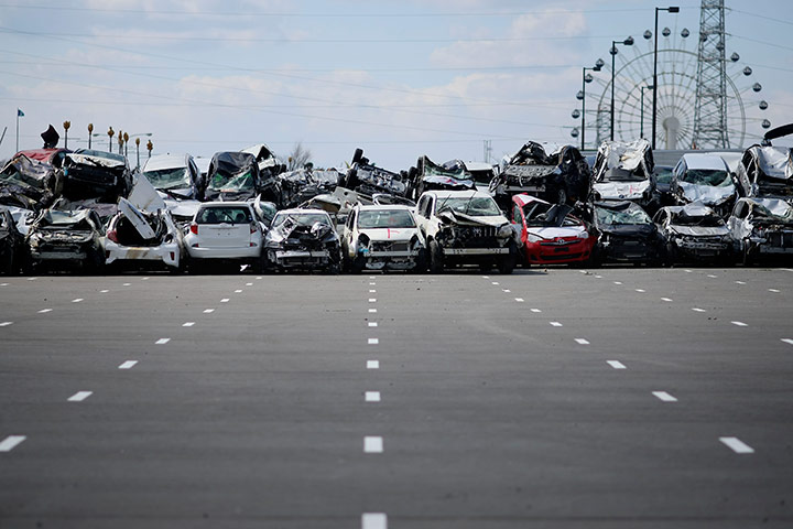 Japan: Damaged Toyota vehicles in parking lot in Sendai, port