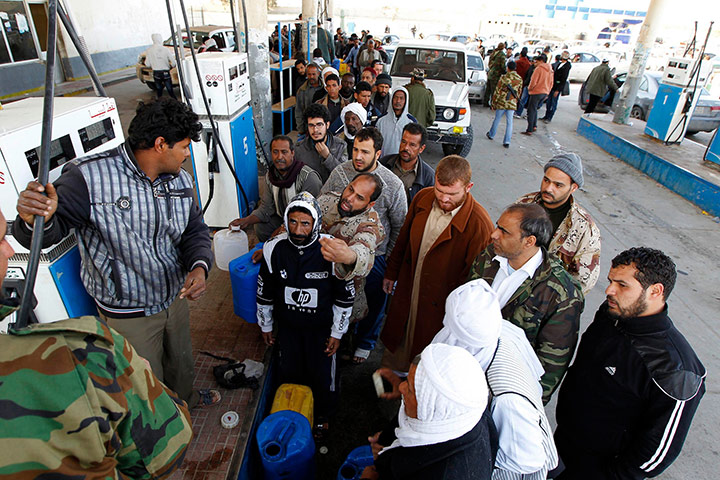 libya today: Advancing rebels queue for fuel at a petrol station in Ajdabiyah