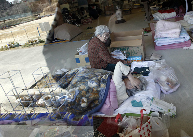 Japan earthquake: Fukushima nuclear accident Elderly women in evacuation shelter