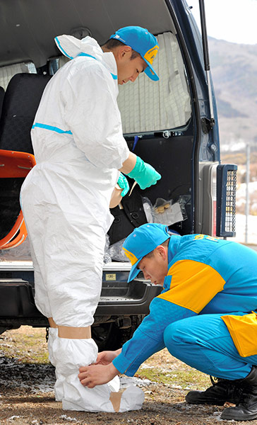 Japan earthquake: Fukushima nuclear accident : police with radiation protective suits