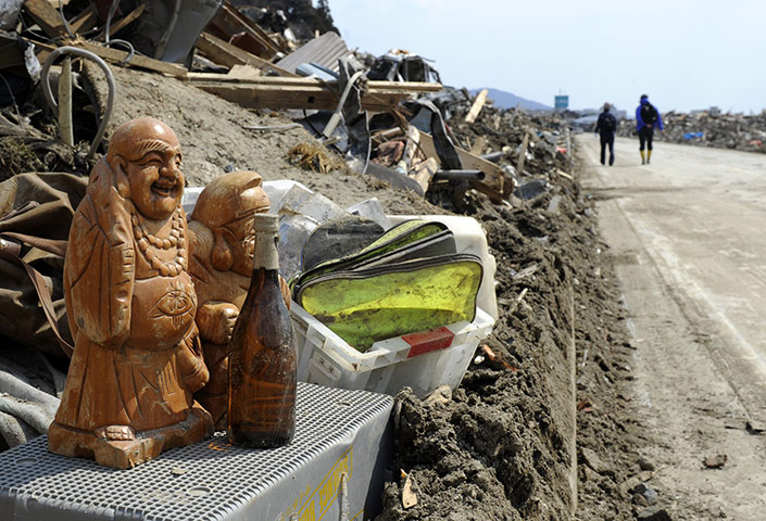 japan: Salvaged religious sculptures are placed beside a road in Rikuzentakata 