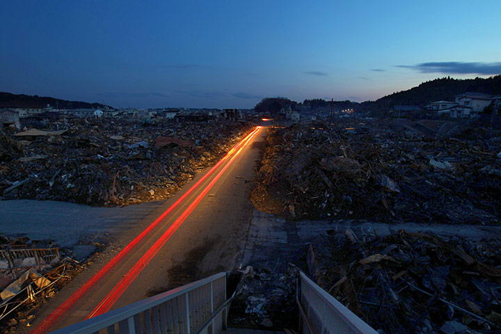 japan: Traffic drives along a road in Kesennuma, Miyagi prefecture