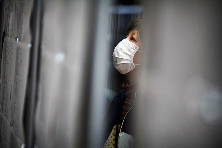 24 hours in pictures: An evacuee looks at boards with names of missing persons in Rikuzentakata