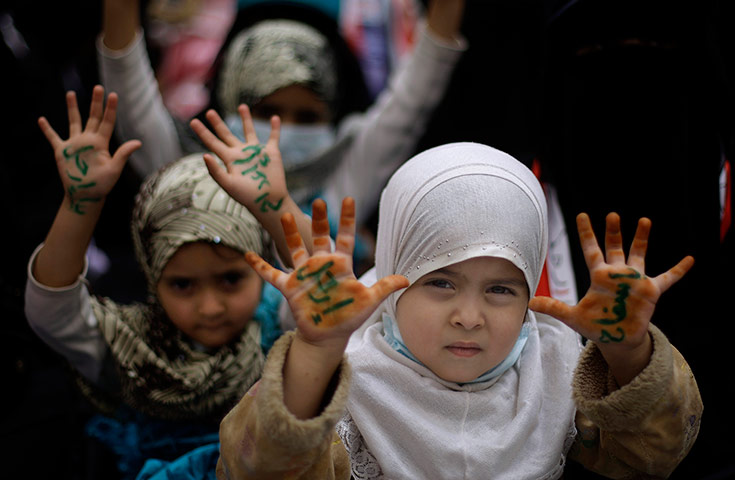 24 hours in pictures: Yemeni girls display their hands during a demonstration