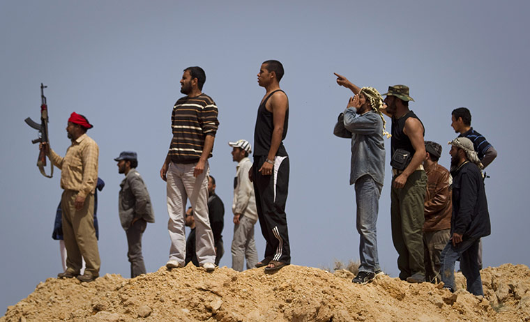 Conflict in Libya: Rebels watch shelling on the frontline outside of Bin Jawaad