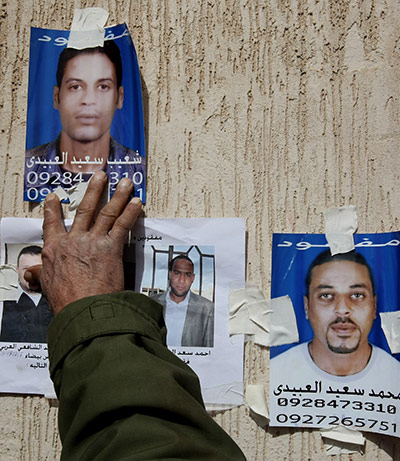 Conflict in Libya: Images of missing men on a wall at the hospital in Ajdabiya 