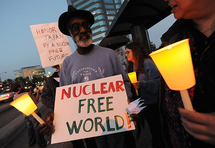 Japan nuclear crisis: Anti-nuclear demonstrators hold a candle