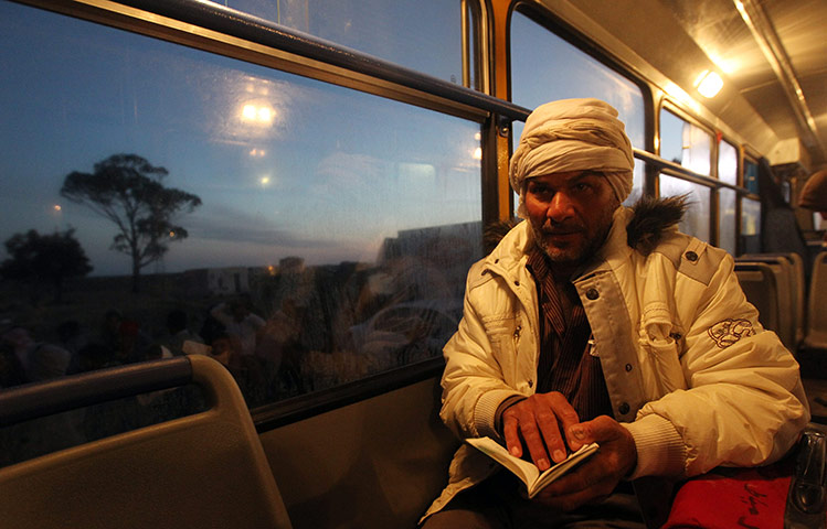 Refugees Flee Libya: An Egyptian resident in Libya on a bus after fleeing the unrest in Libya