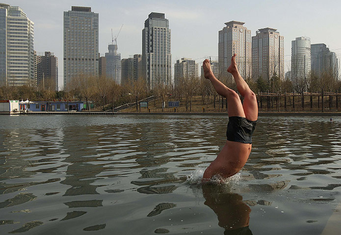 24 hours in pictures: A winter swimmer jumps into a canal in Zhengzhou