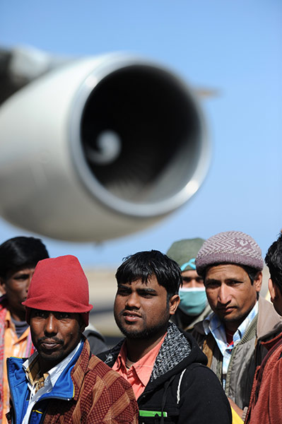 Libya Gallery: Pakistani and Bangladeshi workers who fled Libya wait to be evacuated