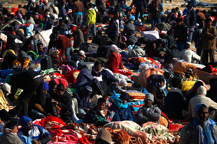 Libya Gallery: Evacuees rest after crossing into Tunisia after fleeing violence in Libya 