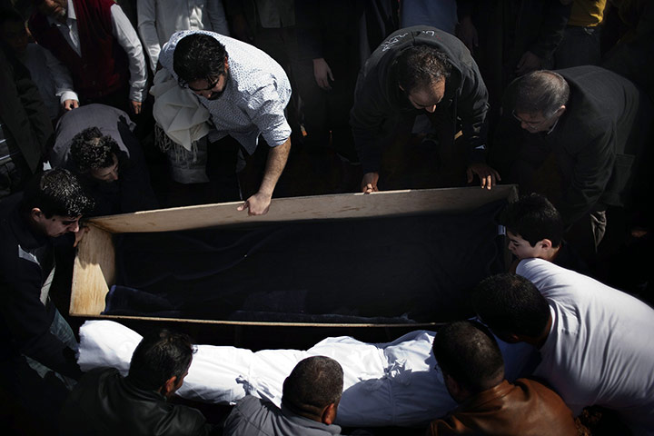 Libya Gallery: People lay down the body of a Libyan rebel killed the day before