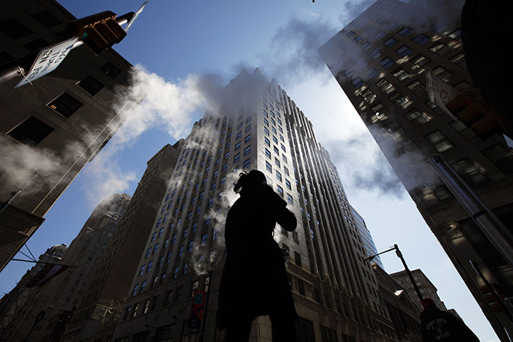 24 hours: A pedestrian passes through steam rising from street vents in Philadelphia