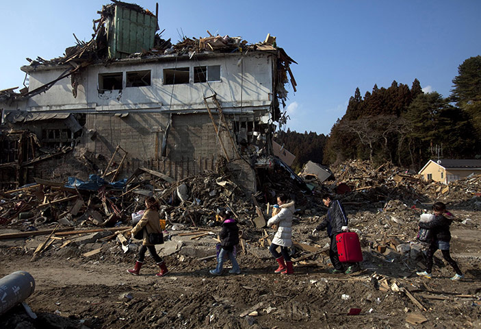 From the agencies: a family salvage their belongings in Rikuzentakata