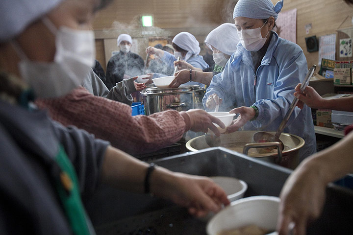 From the agencies: Volunteers serve soup to refugees at a shelter in Rikuzentakata