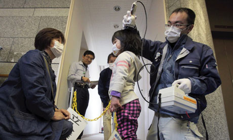 A girl is screened in Iitate, about 40km from the damaged Fukushima nuclear plant, where high levels of radiation have been detected. Photograph: Takumi Harada/AP
