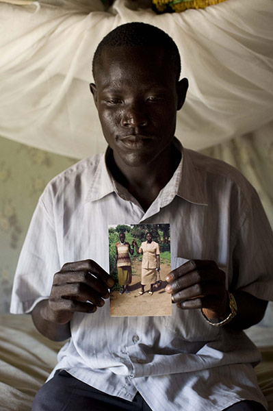 Missing Midwives: William with photo of his wife who died during child birth, Southern Sudan