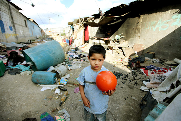 Guatemala Toybox Charity: A boy holds a ball in a Guatemala rubbish dump