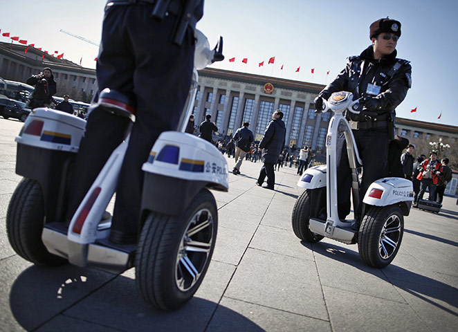 from the agencies: Police ride two-wheel electronic vehicles while patrolling Tiananmen Square