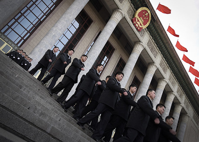 from the agencies: Security guards march out the Great Hall of the People