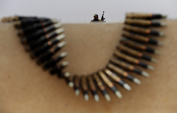 libya unrest continues: A Libyan rebel fighter mans a checkpoint