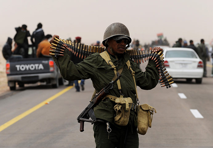 Libya unrest continues: Libyan rebel fighters gather on the outs