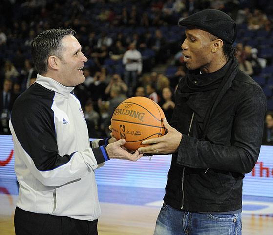 NBA: Didier Drogba presents the matchball to the head referee before tip-off
