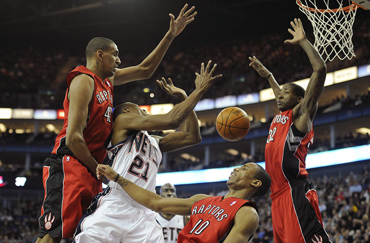 NBA: Toronto Raptor defence block an attack from Travis Outlaw