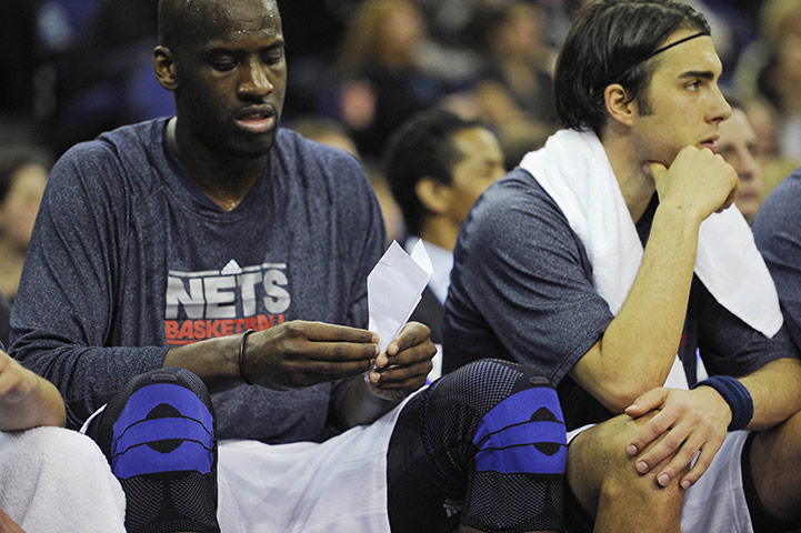 NBA: Johan Petro examines a paper aeroplane