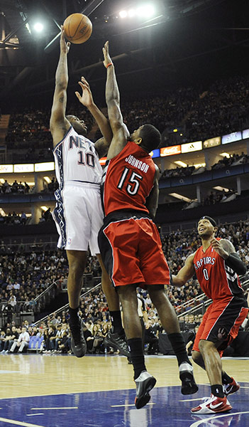 NBA: New Jersey's Damion James scores with a jump-shot over Amir Johnson